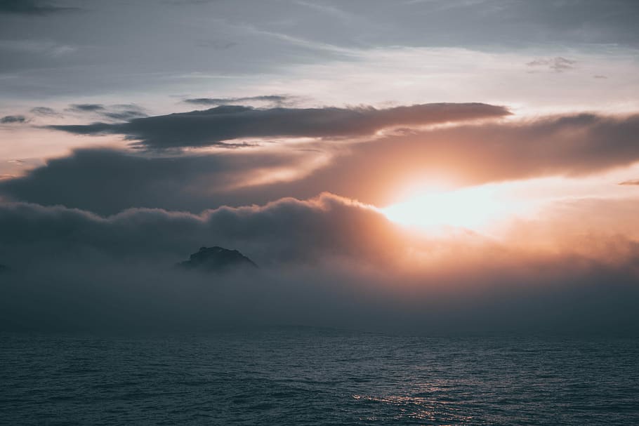 foggy island, cloudy sky during sunset, sunrise, water, sea, cloud - sky HD wallpaper