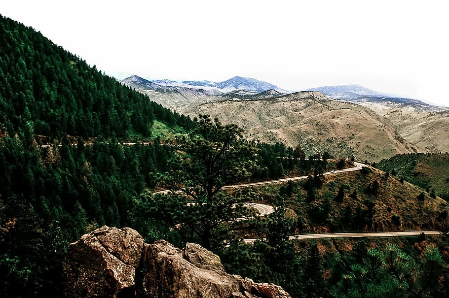 green leaf trees on mountain, brown rocky cliff mountains with roadway HD wallpaper