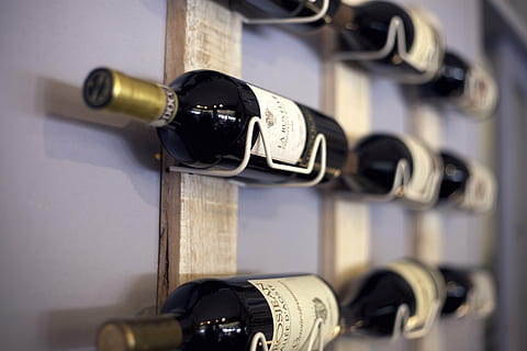 selective focus photography of white labeled wine bottle, wine rack HD wallpaper