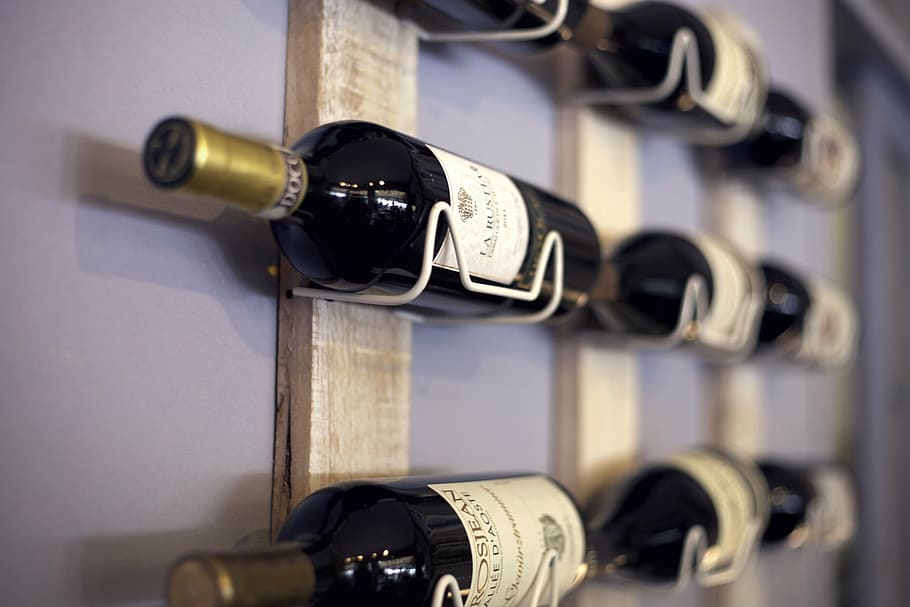 selective focus photography of white labeled wine bottle, wine rack HD wallpaper