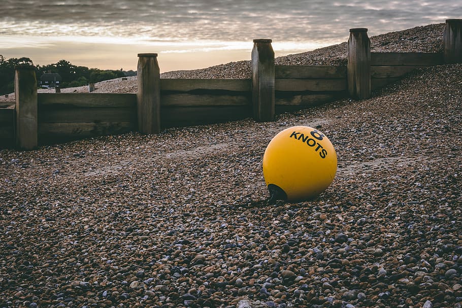 yellow 8 knots ball on pebble, yellow knots floater on seashore, HD wallpaper