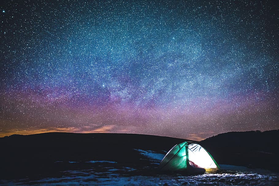 Camping in tent under the stars in the night sky, nature, landscape