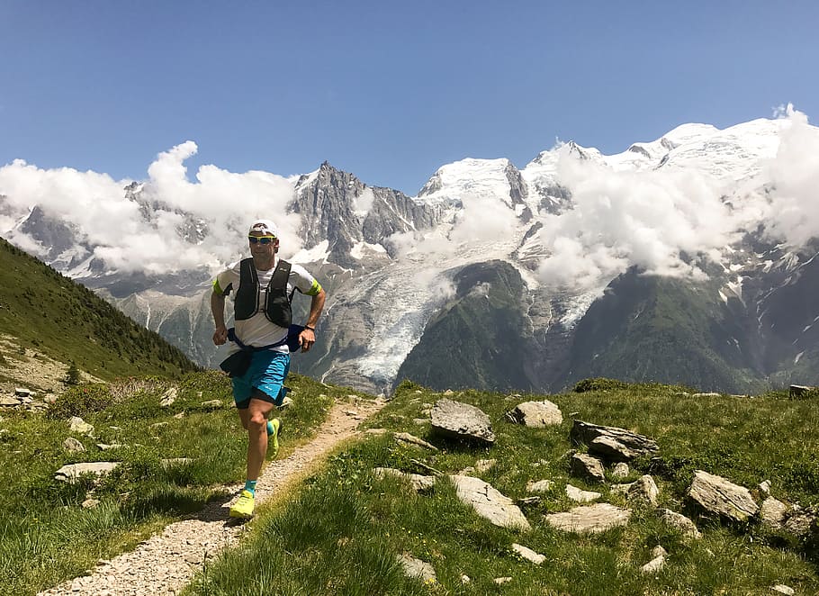 Trail Running in Chamonix, man running beside green grass during daytime