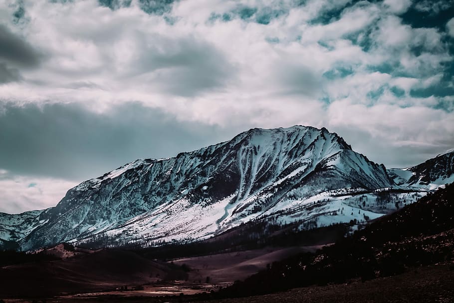 landscape photography of snow-covered mountains, snow covered mountain under cloudy sky HD wallpaper