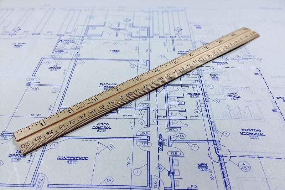 brown wooden ruler on top of floor plan, blueprint, architecture