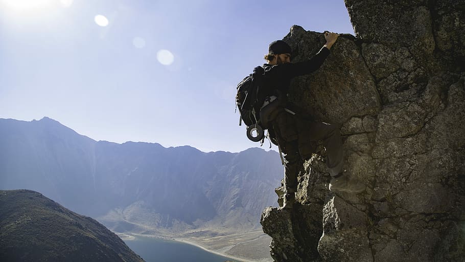 better view, man wearing black long-sleeved shirt rock climbing during daytime landscape photography HD wallpaper