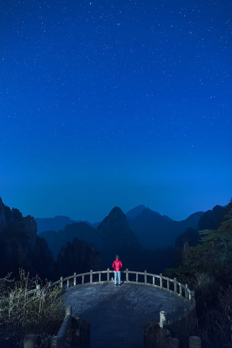 photo of man standing on brown concrete paving, man on mountain during night time HD wallpaper