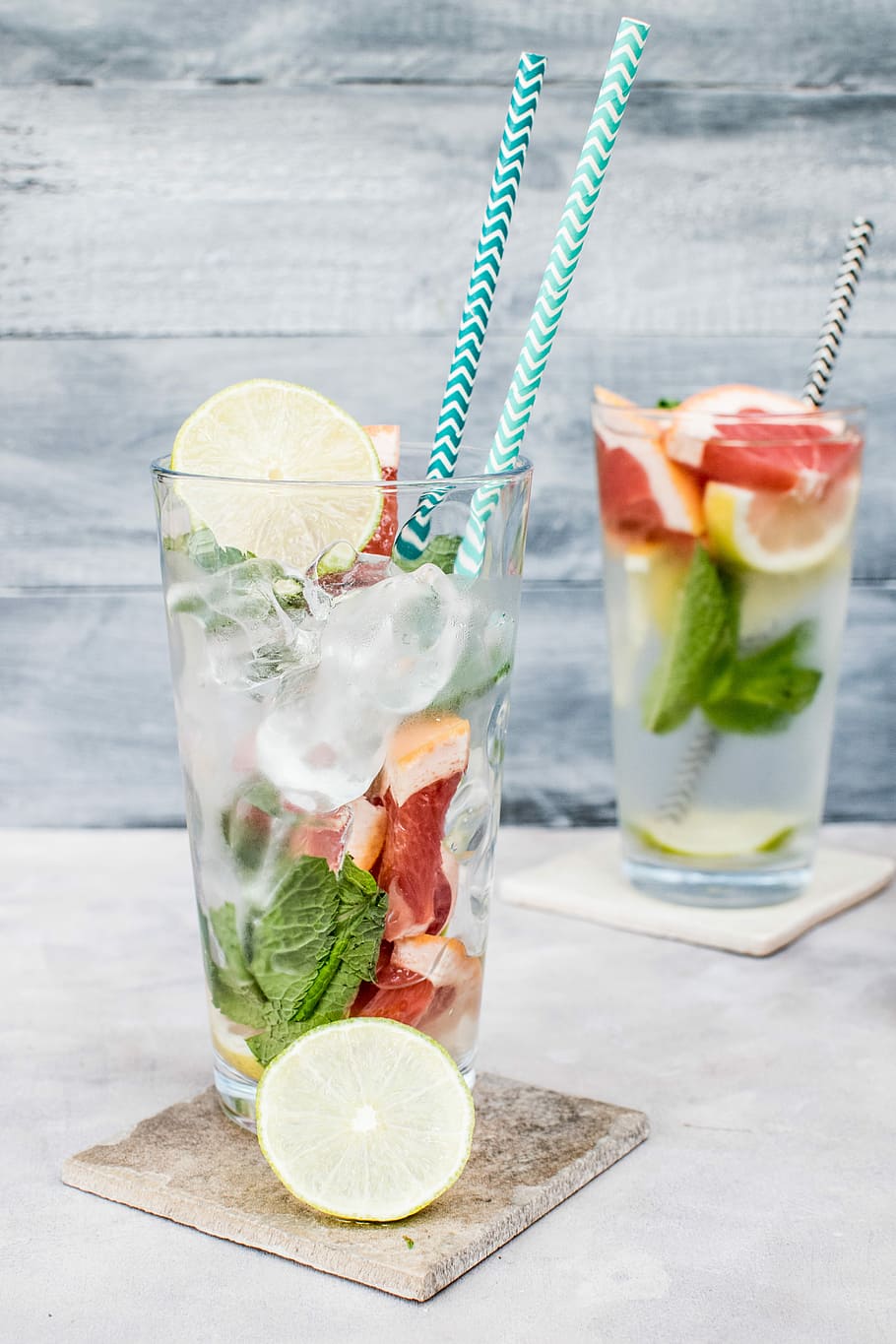 two filled drinking glasses with beverages, highball glass with slice lemon and tube ice HD wallpaper