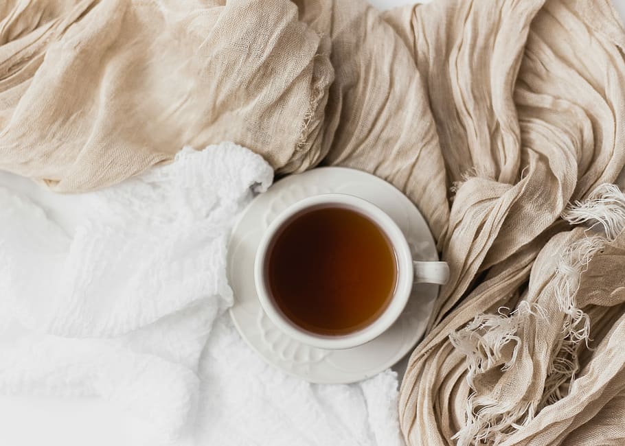 tea filled white ceramic mug on white ceramic saucer, white ceramic teacup filled with brown liquid on white saucer HD wallpaper