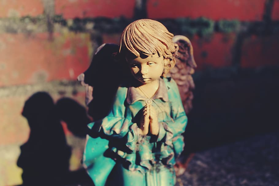 photography of brown-haired angel ceramic figurine, decor, statue
