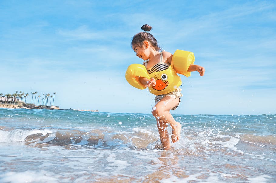 girl playing along seashore during daytime, clear, sky, kid, child