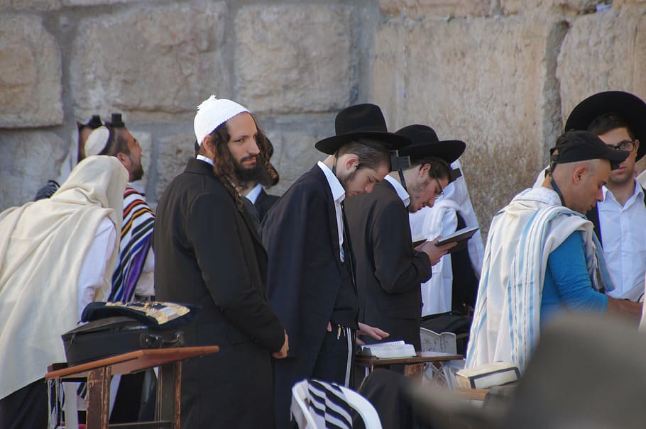 group of people standing on front of wall, wailing wall, judaism