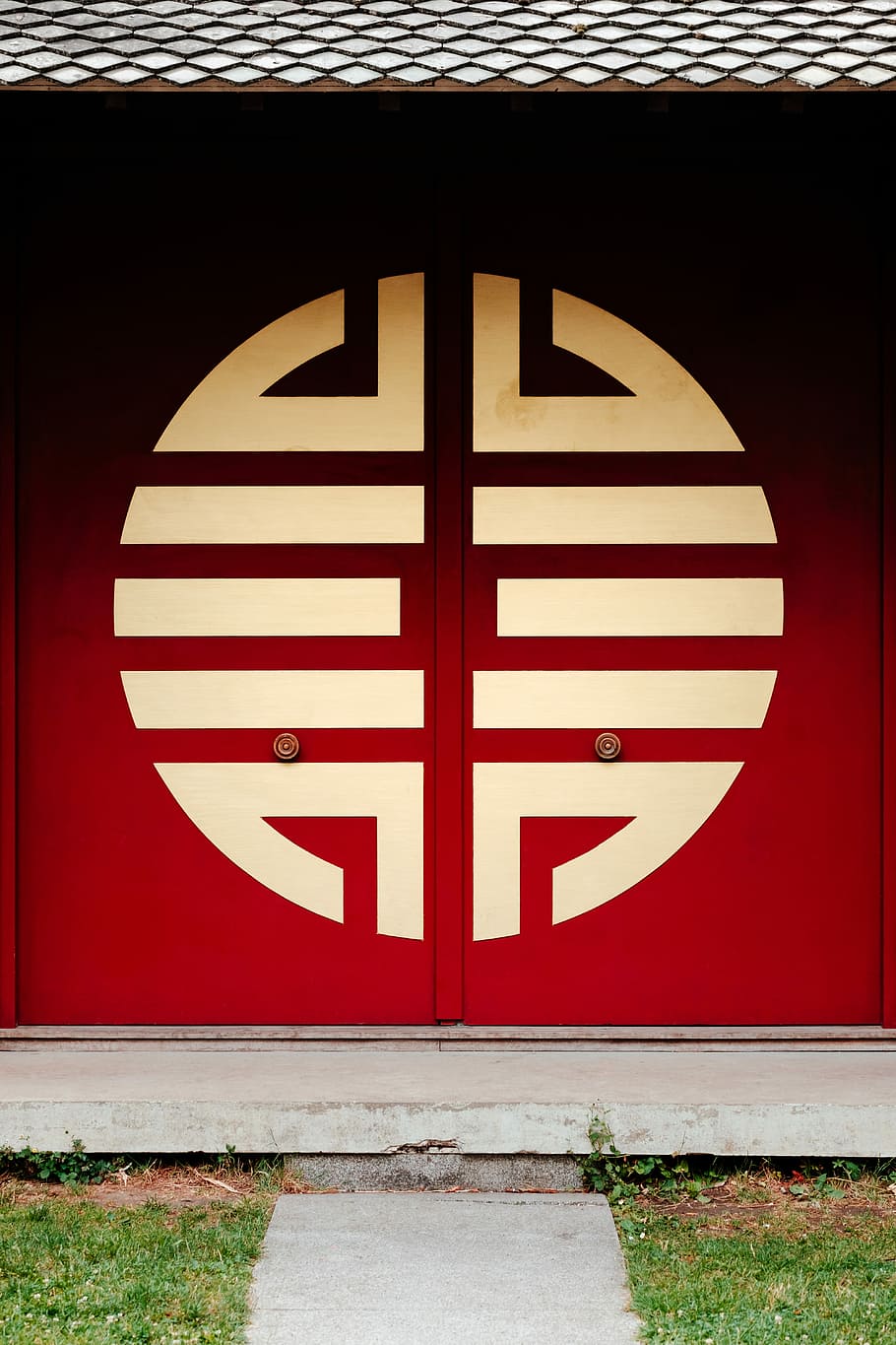 closed red and white painted door, red and white wooden buddhist temple door