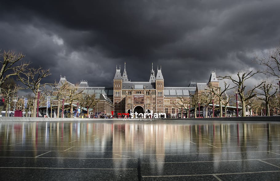 brown building under dark cloudy sky, amsterdam, museum, rijksmuseum