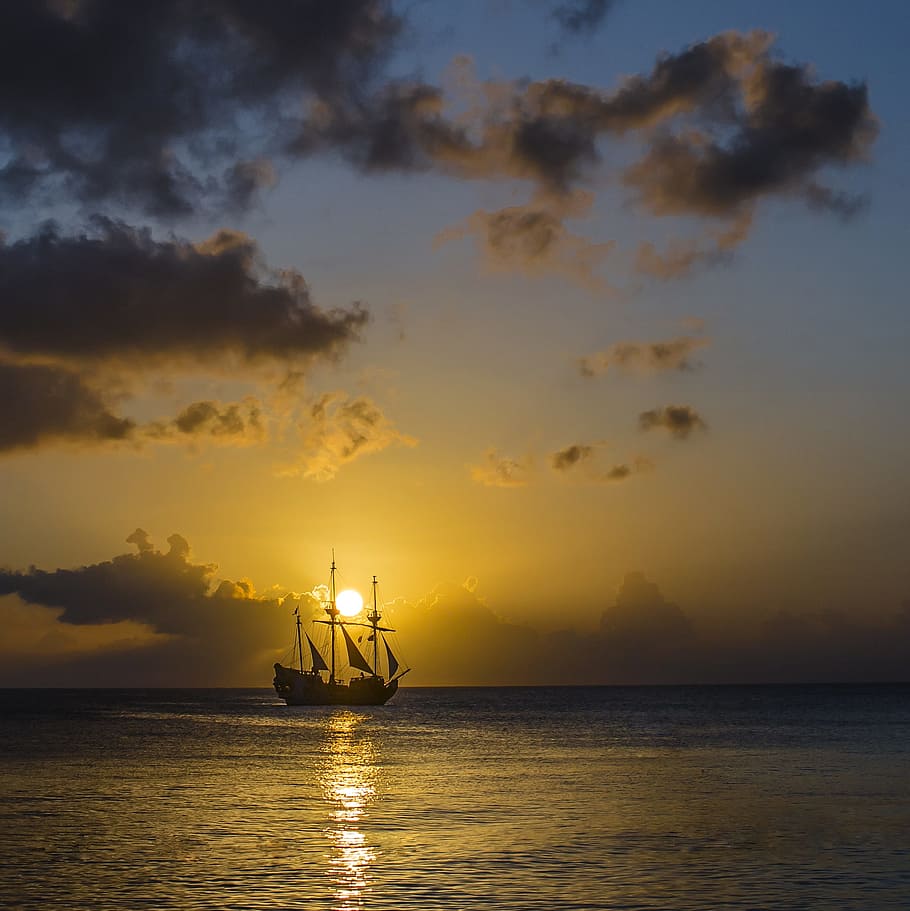 silhouette of galleon ship at sunset, island, sea, landscape