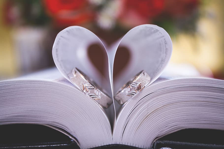 two silver-colored rings on book page, bible, wedding, heart