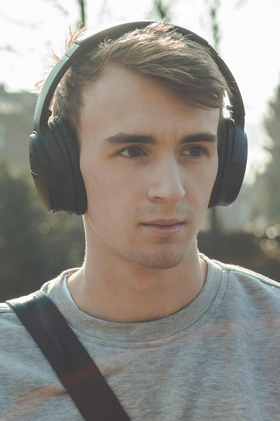 man wearing black Bluetooth headphones, portrait, headshot HD wallpaper