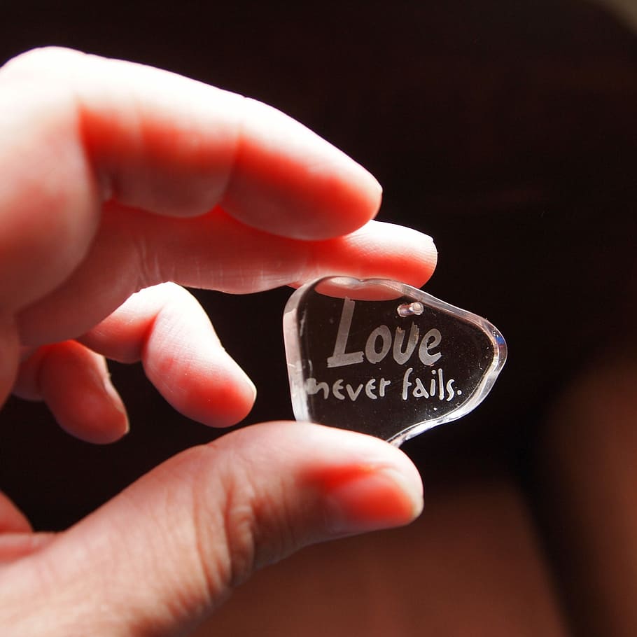 person holding clear laser cut pendant, glass, letters, love, HD wallpaper
