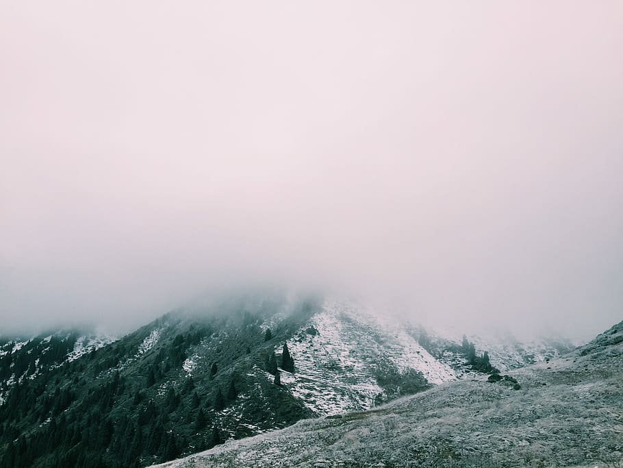 mountain range covered with snow and clouds, aerial photography of mountain with fog HD wallpaper