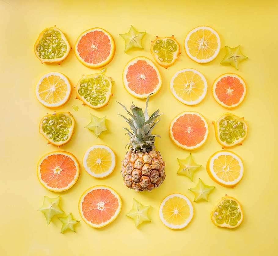 pineapple surrounded by sliced fruits, orange, lemon, starfruit HD wallpaper