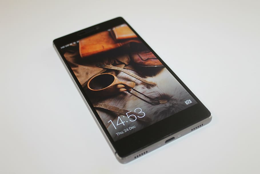 turned-on black smartphone on beige surface, huawei p8, tech HD wallpaper