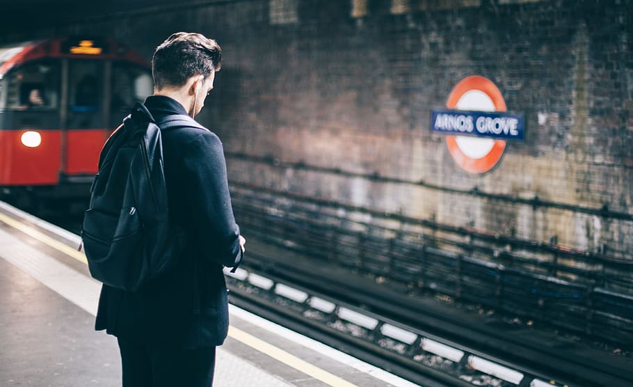 man with backpack standing on train station, man standing on subway, HD wallpaper