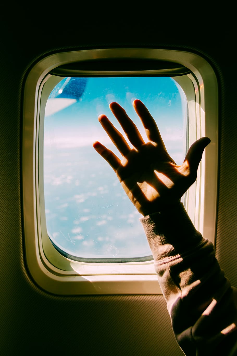 person's hand near airplane window, shadow, arm, sky, blue HD wallpaper