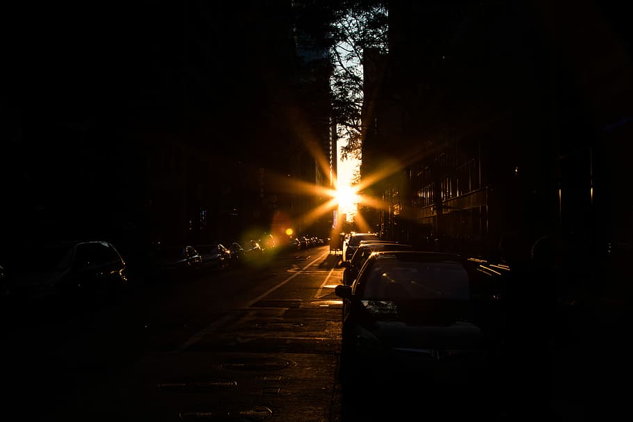 sunset overseeing between two buildings, cars parked in street during sunset HD wallpaper