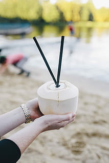 Female holding a fresh coconut, summer, fruit, holidays, vacations HD wallpaper
