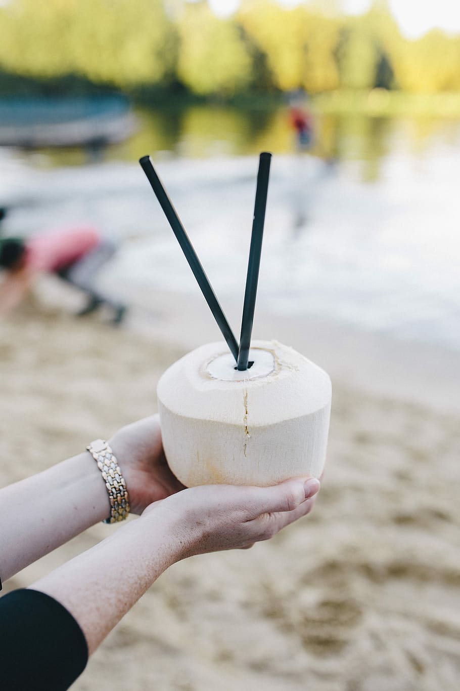Female holding a fresh coconut, summer, fruit, holidays, vacations HD wallpaper