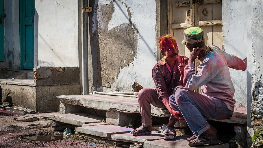 two man sitting on concrete step, holi, men, colorful, people