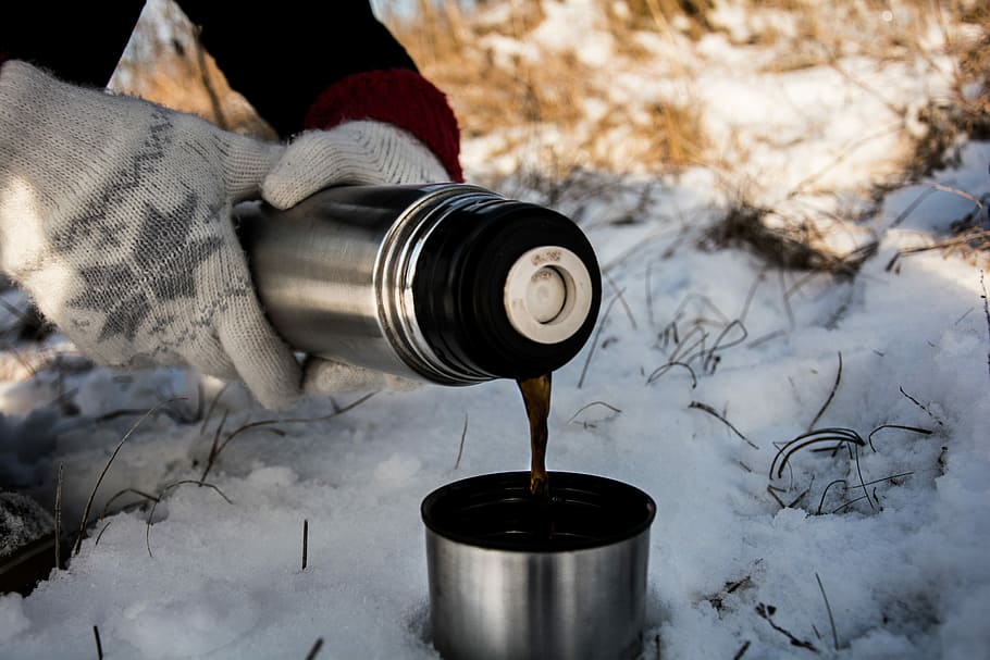 person holding vacuum flask putting brown liquid on cup, person pouring beverage on silver vacuum flask HD wallpaper