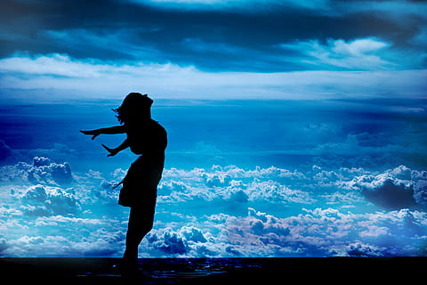 silhouette of standing woman while spreading her arms sideward HD wallpaper