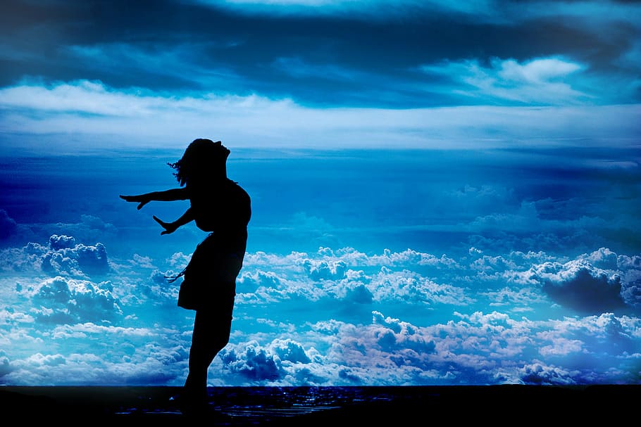silhouette of standing woman while spreading her arms sideward HD wallpaper