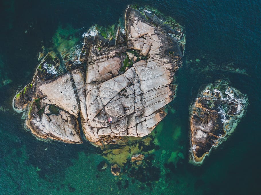 brown rock formation on water aerial photogrpahy, aerial view of islet HD wallpaper