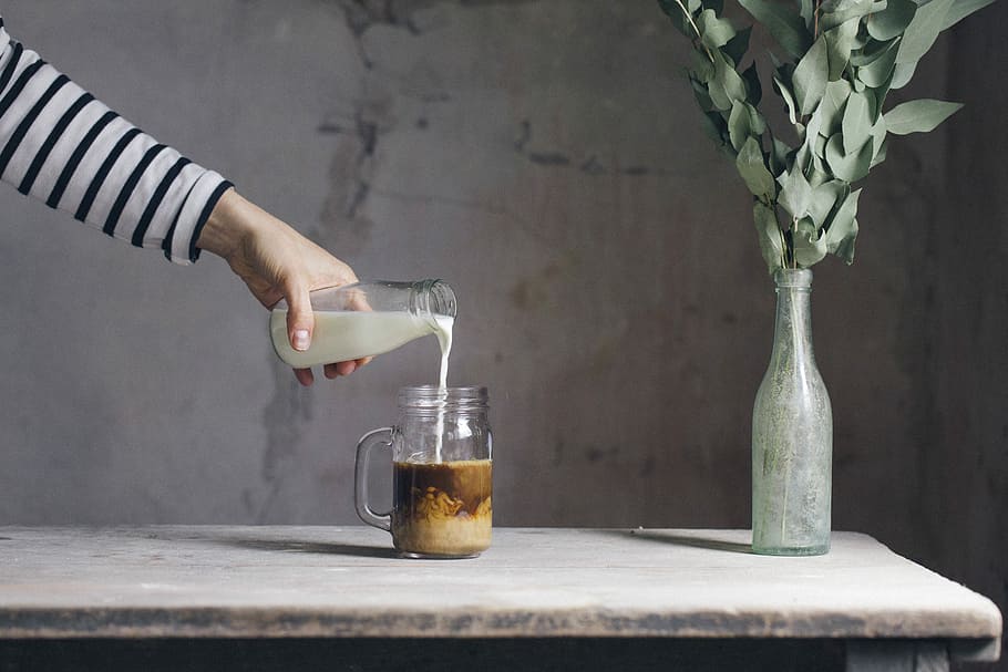 person filling milk on glass, person's hand puoring milk into glass HD wallpaper