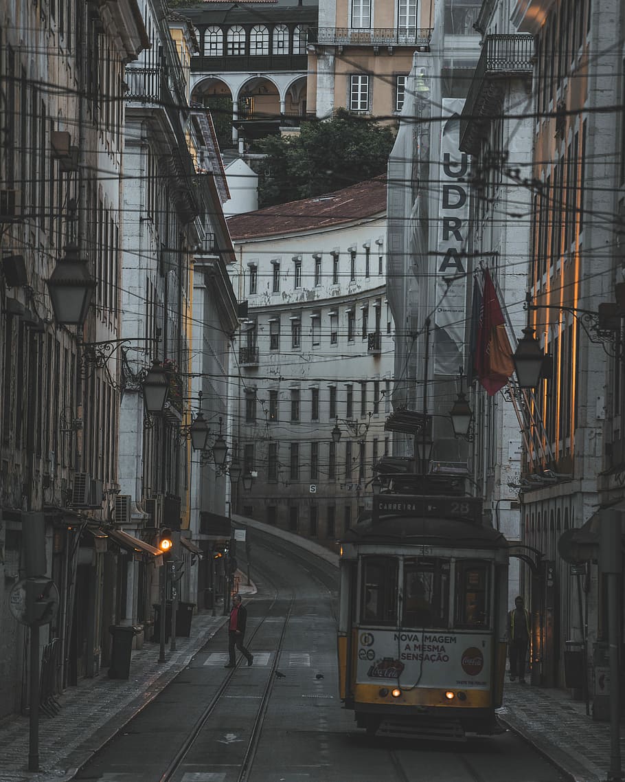 several people in white tram in city, white and yellow city tram in middle of alleyway during sunset HD wallpaper