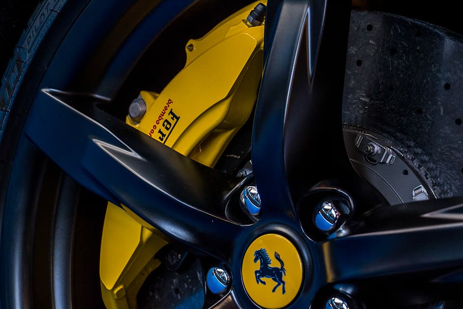 closeup photo of vehicle Ferrari wheel and tire, Ferrari wheel with yellow brake caliper