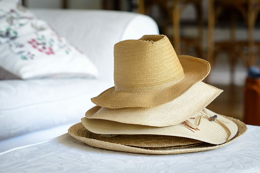 HD wallpaper: five brown straw nesting hats on white textile, stack of  brown sunhats beside white couch