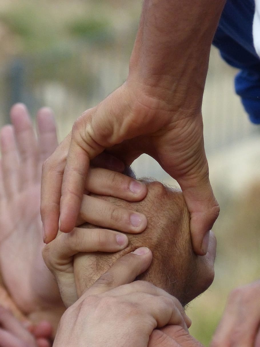 close-up photography of people holding hands, castells, collaboration HD wallpaper