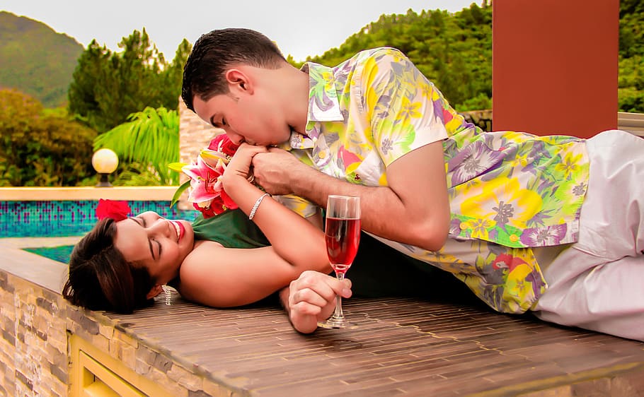 man kissing woman's right hand while lying on brown surface, wedding, HD wallpaper