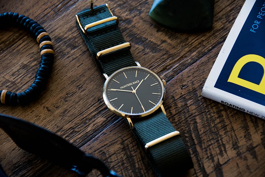 round silver-colored analog watch with black strap, round gold-colored analog watch with black leather strap beside black bracelet HD wallpaper