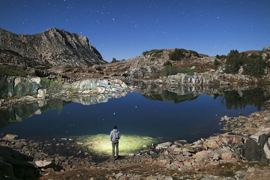 Frozen in a dreamscape, man standing near lake during daytime photo HD wallpaper