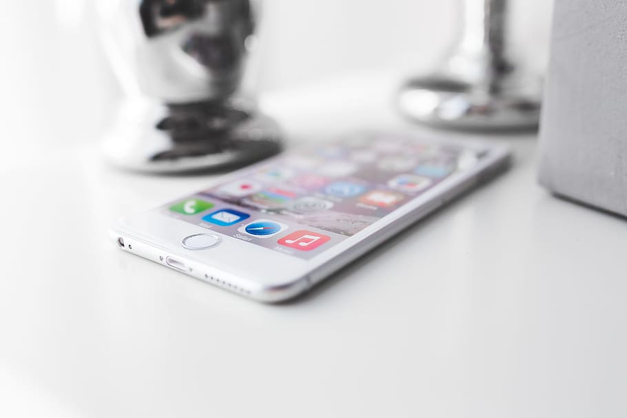 Apple iPhone 6 Plus on a white desk, closeup, device, digital