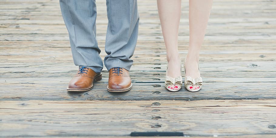man wearing brown leather oxford shoes beside woman wearing gold open-toe sandals, man and woman standing on wooden surface, HD wallpaper