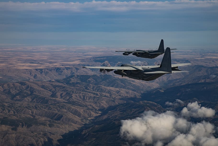 two black fighter jet on mid-air during daytime, kc-130j hercules
