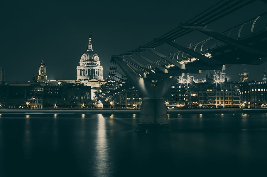A view of St. Paul's Cathedral and the Millennium Bridge in London, gray steel bridge