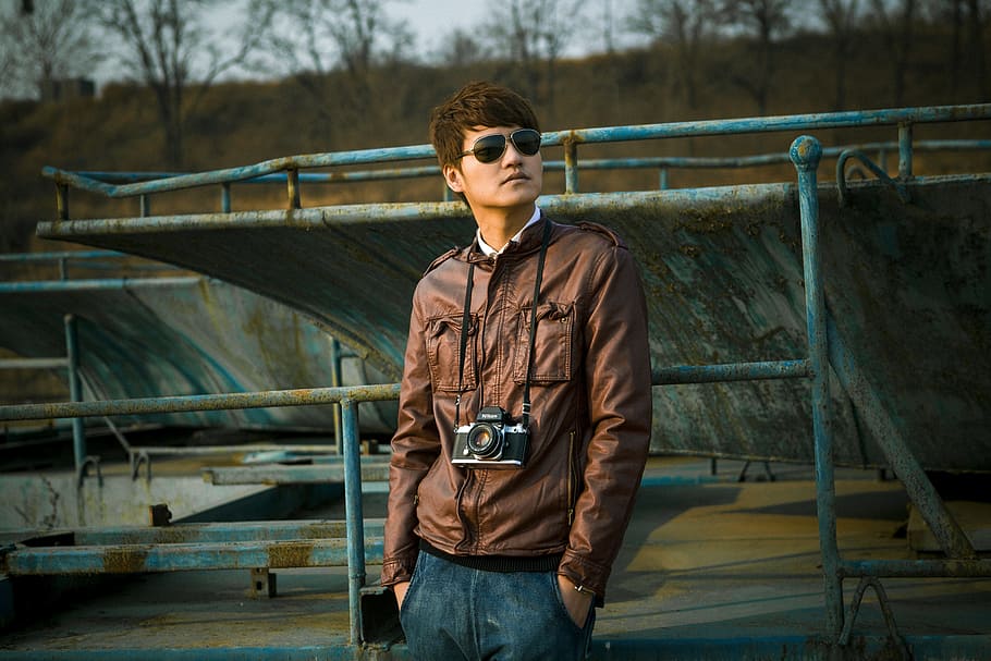 man wearing brown leather jacket near blue metal fence, people HD wallpaper