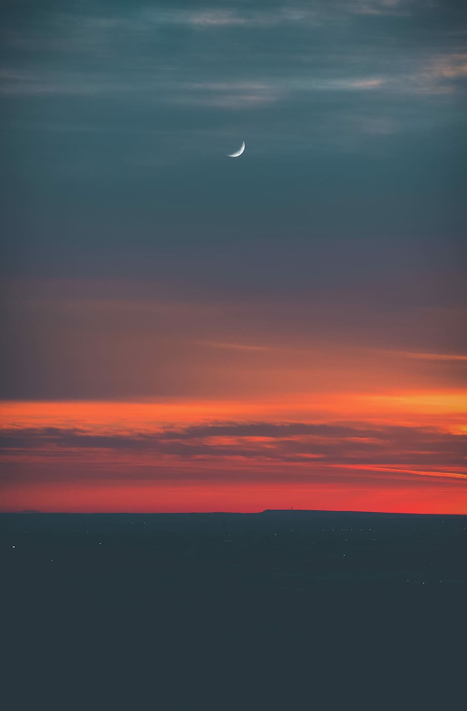 sea horizon during golden hour time, photography of sunset with a scene of half moon
