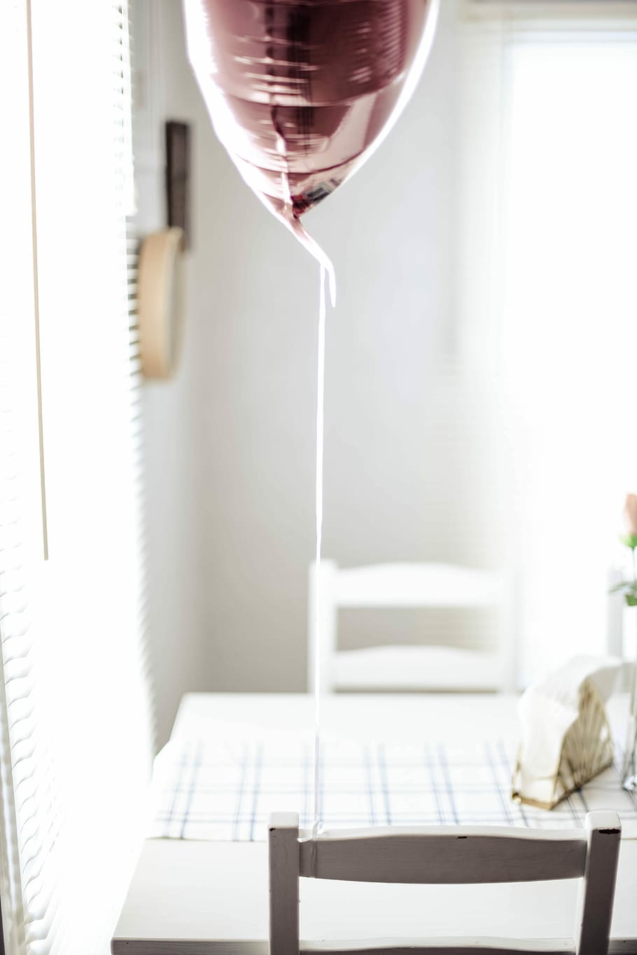 minimalist photography of balloon tied on chair, brown balloon on white wooden chair HD wallpaper